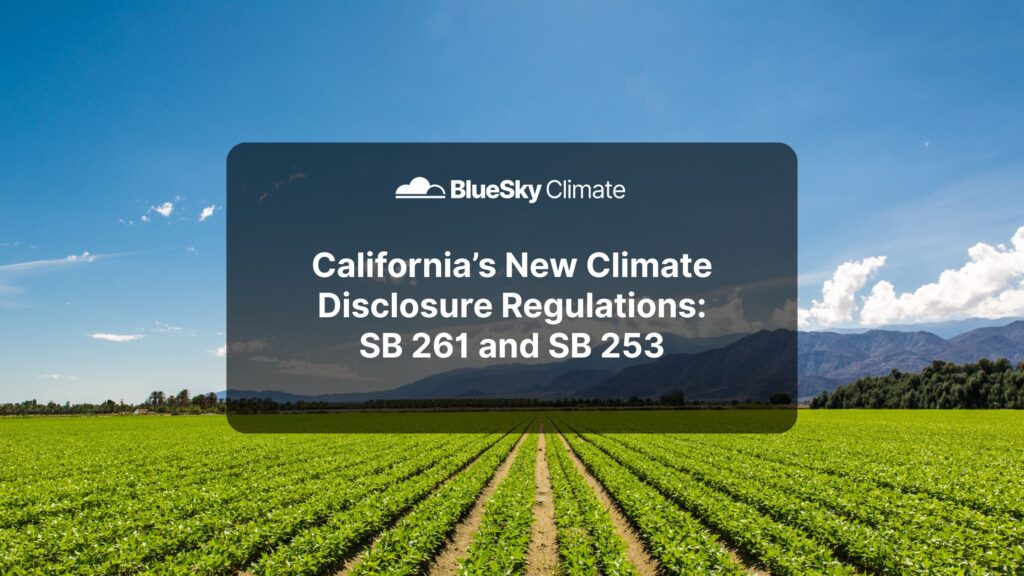 Wide view of a green agricultural field under a bright blue sky with mountain backdrop and Blue Sky Climate Insights logo, highlighting an update on California SB 261 and SB 253 climate disclosure laws.